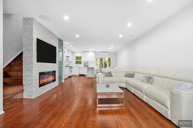 82-15 Penelope Ave, New York City, NY 11379 - living room featuring a fireplace, wood finished floors, recessed lighting, and an AC wall unit