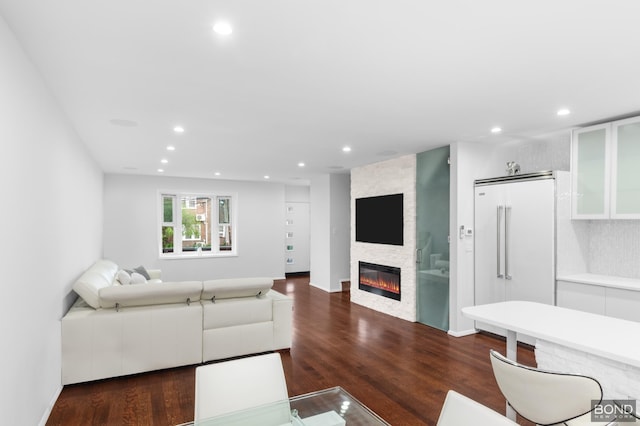 82-15 Penelope Ave, New York City, NY 11379 - living room featuring recessed lighting, a large fireplace, dark wood-style floors, and baseboards