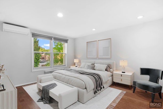 82-15 Penelope Ave, New York City, NY 11379 - bedroom featuring a wall mounted AC, recessed lighting, wood finished floors, baseboards, and radiator