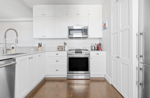 755 W End Ave Unit 15C, New York City, NY 10025 - kitchen featuring appliances with stainless steel finishes, light countertops, a sink, and white cabinets