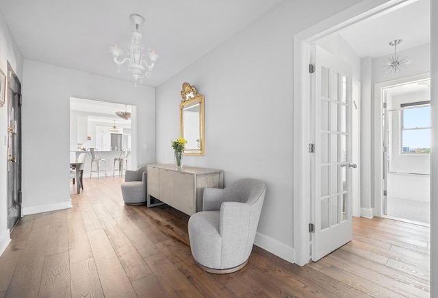 755 W End Ave Unit 15C, New York City, NY 10025 - hall featuring a chandelier, wood-type flooring, and baseboards