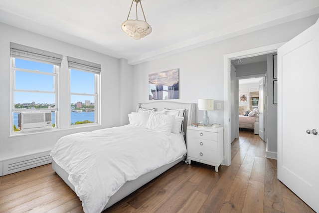 755 W End Ave Unit 15C, New York City, NY 10025 - bedroom with a baseboard radiator, dark wood-type flooring, and cooling unit
