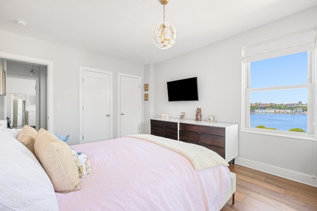 755 W End Ave Unit 15C, New York City, NY 10025 - bedroom featuring baseboards, light wood-style flooring, and a chandelier