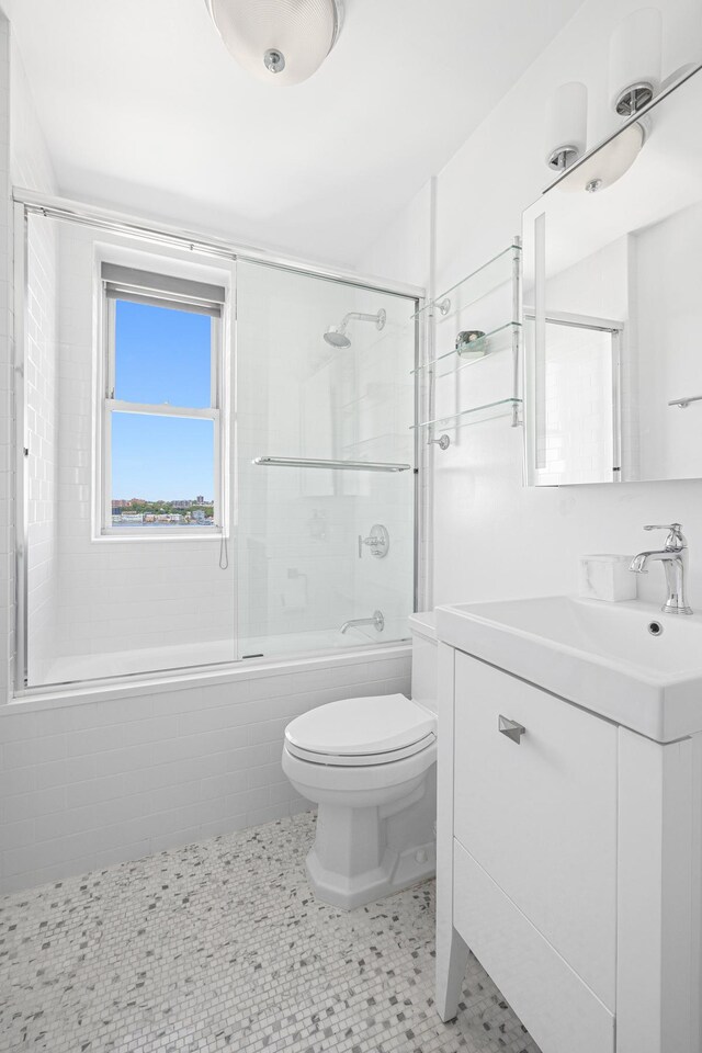 755 W End Ave Unit 15C, New York City, NY 10025 - bathroom with toilet, bath / shower combo with glass door, and vanity