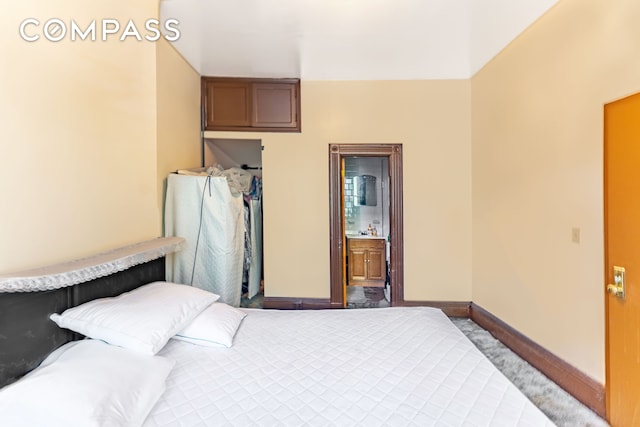 1274 Herkimer St, New York City, NY 11233 - bedroom with baseboards, carpet, and ensuite bathroom