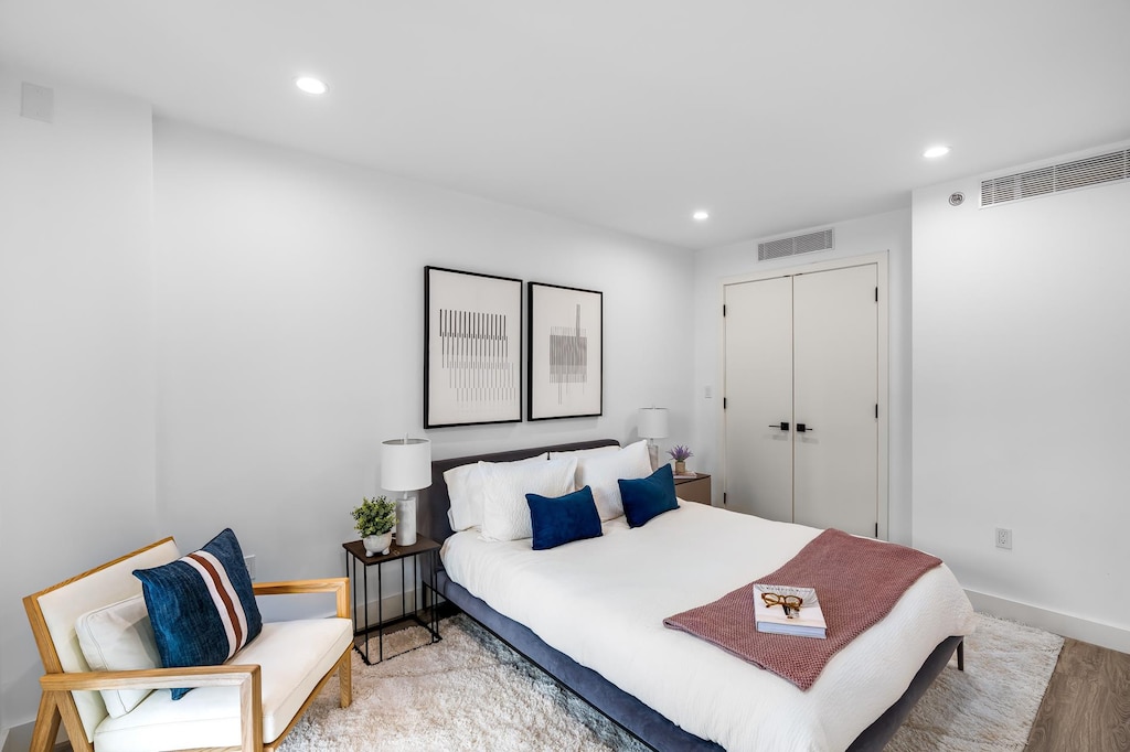 bedroom featuring recessed lighting, baseboards, a closet, and light wood finished floors