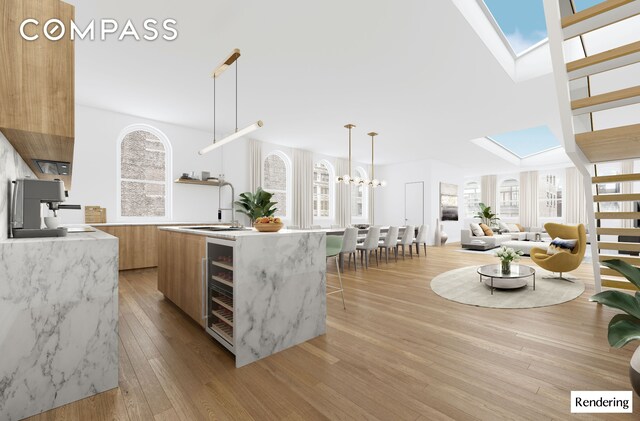 kitchen with modern cabinets, a skylight, a sink, beverage cooler, and open shelves