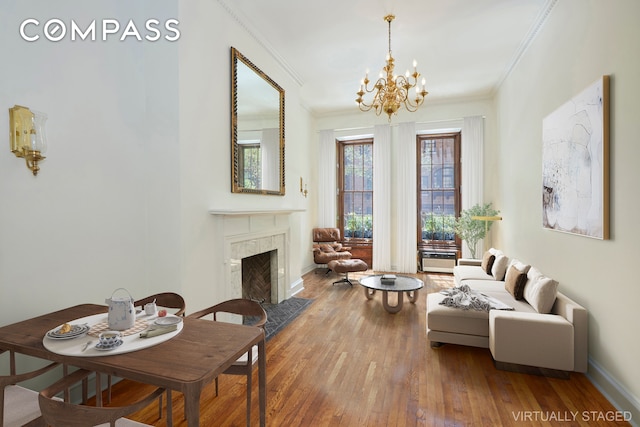 157 E 75th St Unit 1E, New York City, NY 10021 - living room with crown molding, a chandelier, wood-type flooring, a premium fireplace, and baseboards