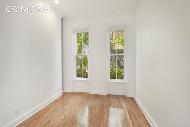 157 E 75th St Unit 1E, New York City, NY 10021 - spare room with light wood-style floors, baseboards, and ornamental molding