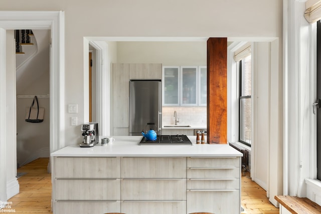 185 12th St, New York City, NY 11215 - bathroom with healthy amount of natural light, a sink, hardwood / wood-style flooring, and backsplash