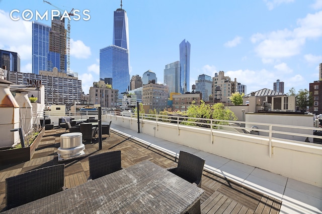 view of patio featuring a view of skyline and a balcony