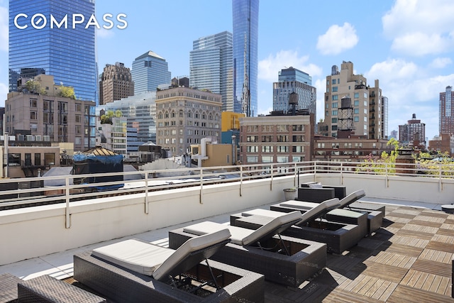 view of patio with a skyline view and a balcony
