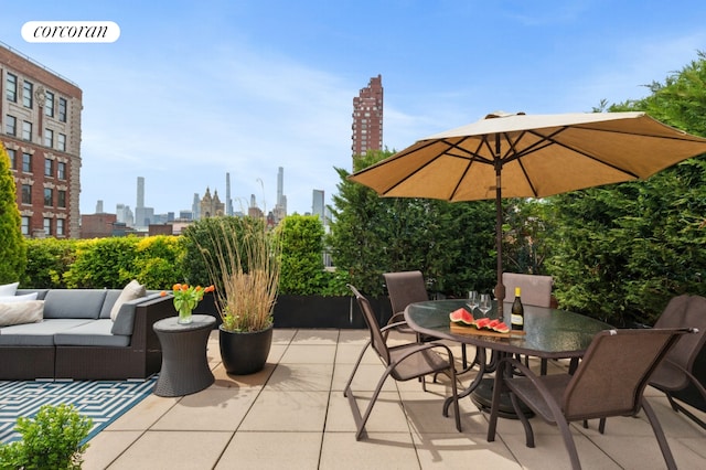 view of patio featuring an outdoor living space, a view of skyline, and outdoor dining area