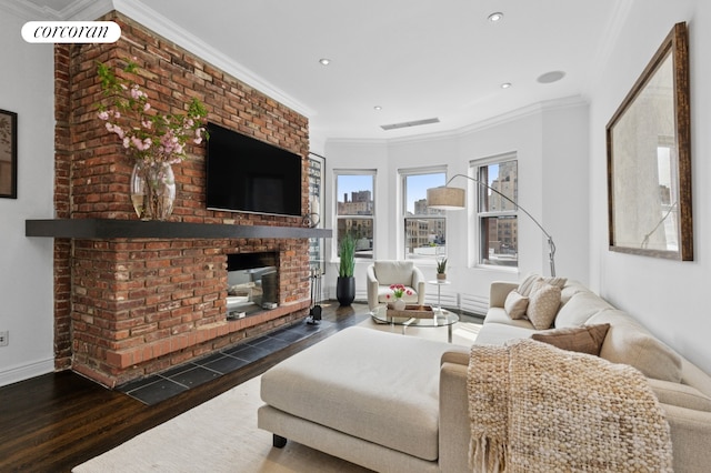 living area featuring a fireplace, wood finished floors, baseboards, crown molding, and recessed lighting