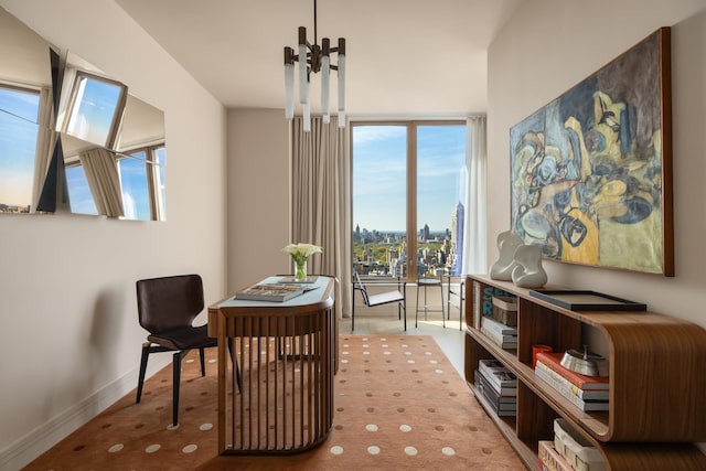 sitting room featuring baseboards, carpet flooring, and a chandelier