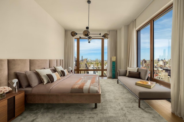 bedroom with a view of city and access to outside