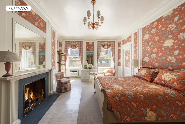bedroom with a chandelier, a fireplace with flush hearth, wallpapered walls, a wall mounted AC, and ornamental molding