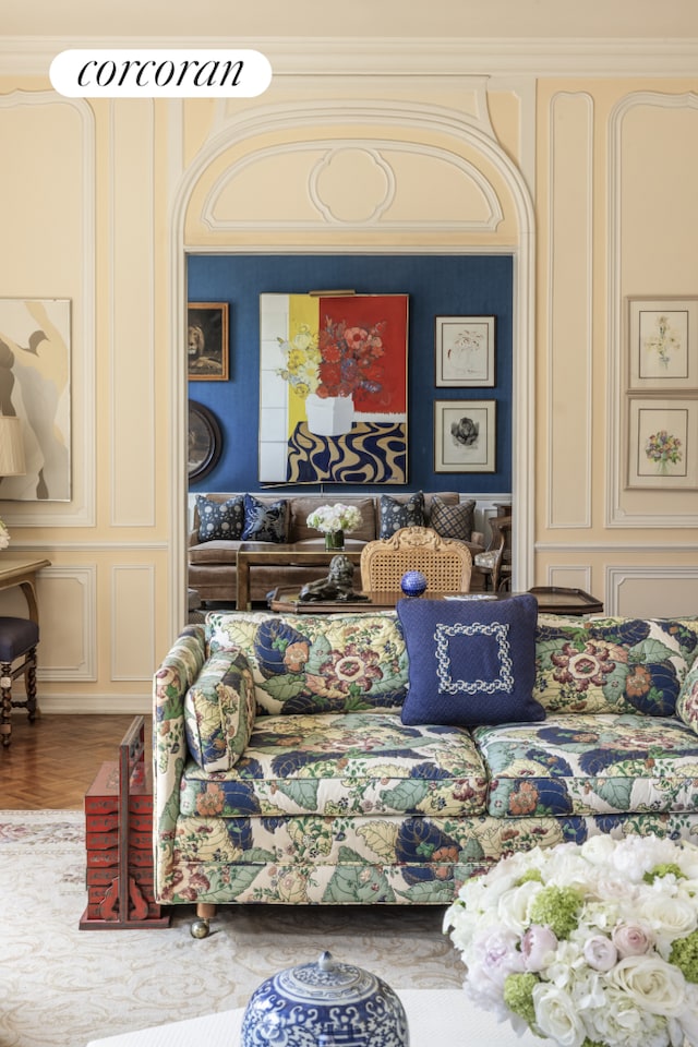 bedroom featuring a decorative wall, crown molding, and wood finished floors
