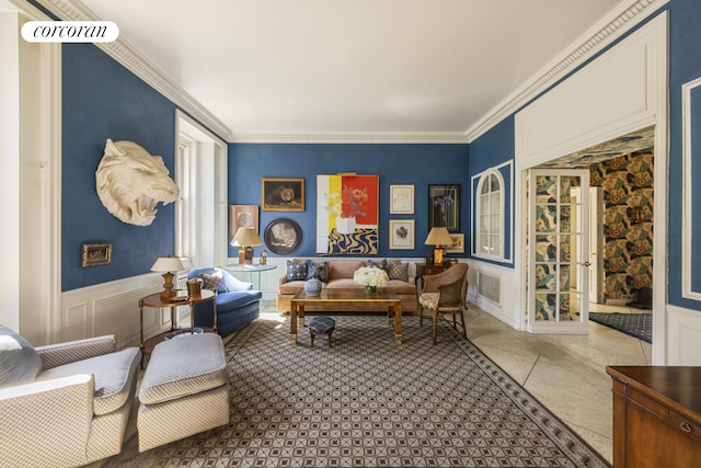 sitting room featuring a wainscoted wall, ornamental molding, and a decorative wall