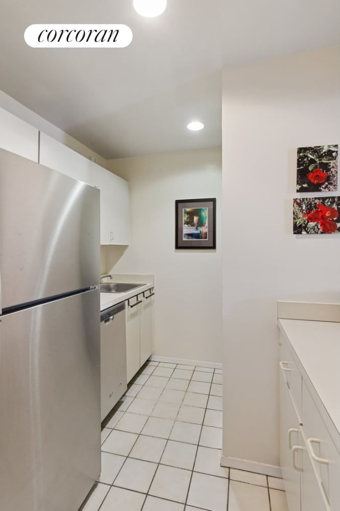 kitchen featuring stainless steel appliances, light countertops, white cabinets, and recessed lighting