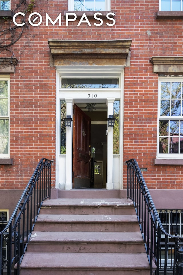 property entrance with brick siding