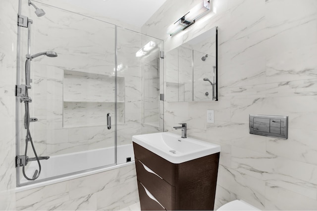 bathroom featuring combined bath / shower with glass door, vanity, and toilet