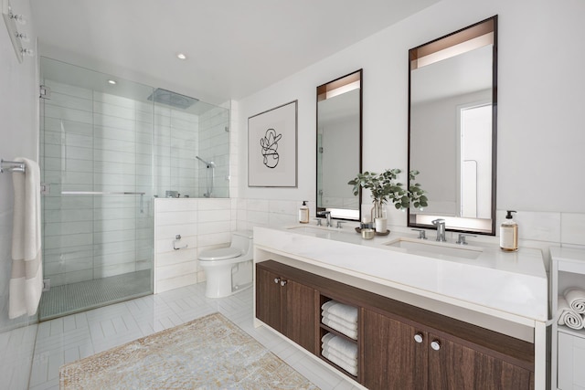 full bathroom with a shower stall, toilet, tile walls, double vanity, and tile patterned flooring