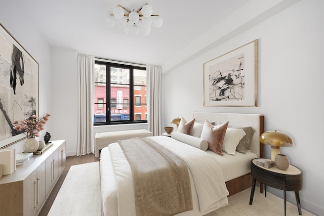 bedroom with a chandelier and light wood-style floors
