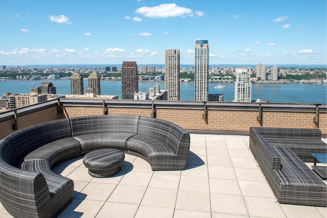view of patio / terrace with a water view and a city view