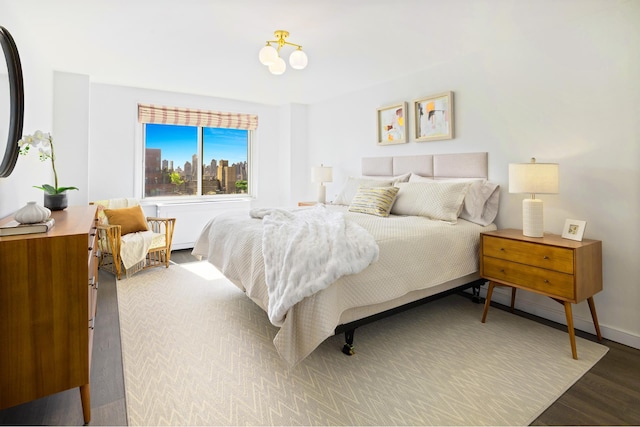 bedroom with wood finished floors and baseboards