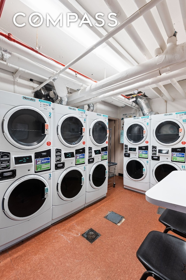 community laundry room with stacked washer and clothes dryer, washer and dryer, and tile patterned floors