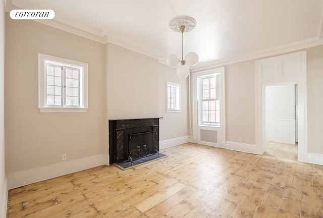 3 E 9th St, New York City, NY 10003 - unfurnished living room with crown molding, a chandelier, hardwood / wood-style flooring, baseboards, and a fireplace
