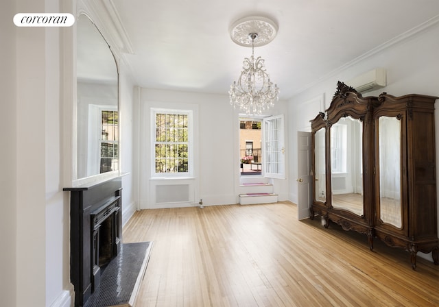 3 E 9th St, New York City, NY 10003 - unfurnished living room with a premium fireplace, wood-type flooring, a chandelier, baseboards, and a wall unit AC