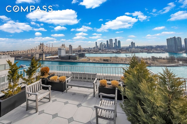view of patio featuring a view of skyline and a water view
