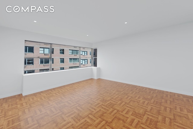 spare room with baseboards and recessed lighting
