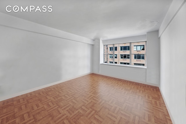 spare room featuring baseboards