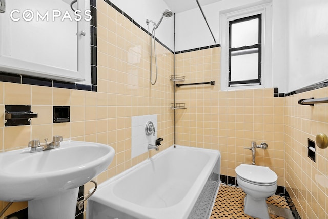 43-08 41st St Unit 5D, New York City, NY 11104 - bathroom with tile walls, toilet, bathing tub / shower combination, and a sink