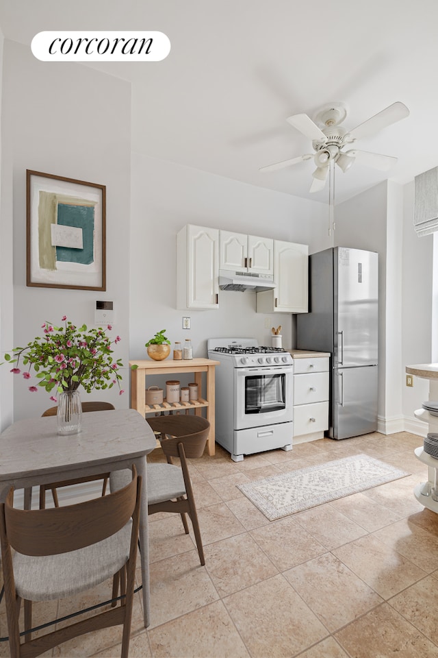 728 41st St Unit 3C, New York City, NY 11232 - kitchen with white gas range, freestanding refrigerator, under cabinet range hood, white cabinetry, and ceiling fan
