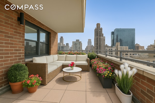 balcony featuring a skyline view and an outdoor hangout area