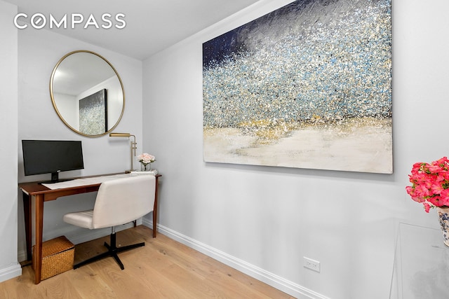 home office featuring wood finished floors and baseboards