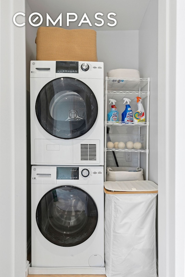 washroom with stacked washing machine and dryer