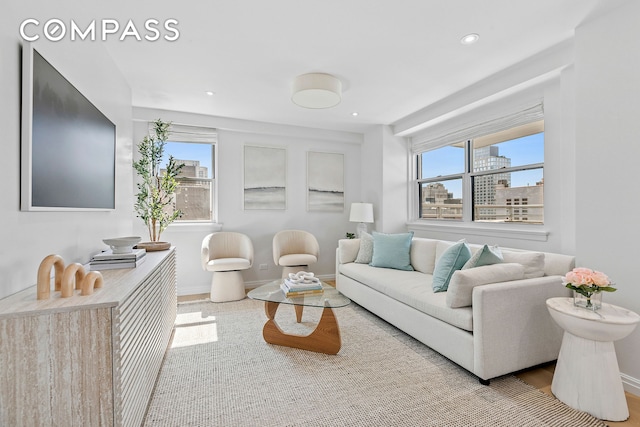 living area featuring baseboards and recessed lighting