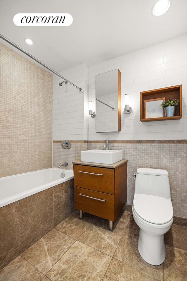 500 4th Ave Unit 10I, New York City, NY 11215 - bathroom with tile walls, tiled shower / bath, vanity, toilet, and tile patterned flooring