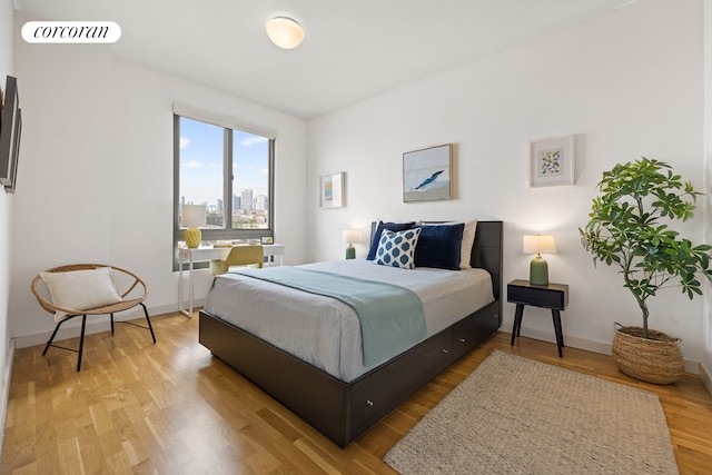 500 4th Ave Unit 10I, New York City, NY 11215 - bedroom featuring wood finished floors, baseboards, and a city view