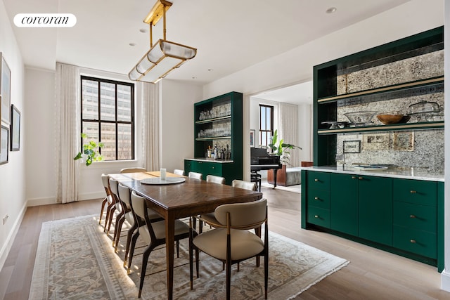 100 Barclay St Unit 20B, New York City, NY 10007 - dining room featuring light wood-type flooring, baseboards, and wet bar