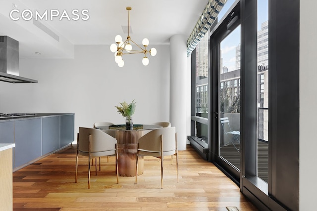 101 Warren St Unit 11L, New York City, NY 10007 - dining space with a chandelier and light wood-type flooring