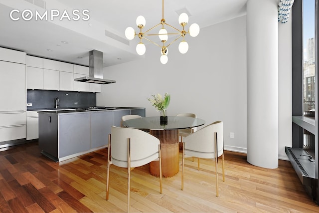 101 Warren St Unit 11L, New York City, NY 10007 - dining space featuring light wood finished floors and a chandelier