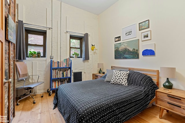 bedroom with light wood-type flooring and radiator