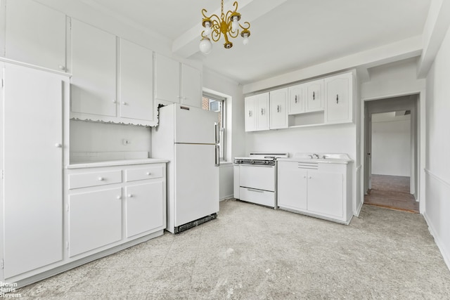 550 Grand St Unit G11D, New York City, NY 10002 - kitchen featuring white appliances, light countertops, white cabinetry, and a chandelier