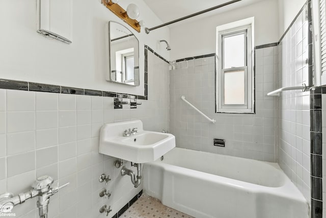full bath with tile walls, shower / bathtub combination, and wainscoting